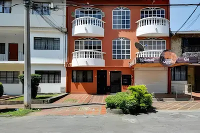 an orange and white building with white balconies at La 70 Laureles 302 - Fresh & Well Apt/Priv balcony in Guayaquil