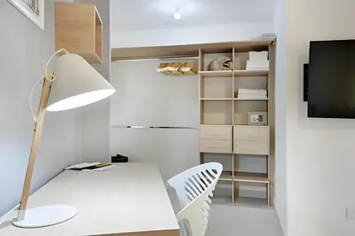 a white room with a desk and a lamp at La 70 Laureles 302 - Fresh & Well Apt/Priv balcony in Guayaquil