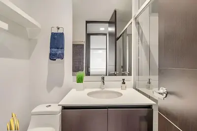 a white bathroom with a sink and a mirror at Life 1202 - Pleasant Apt in Poblado with AC in El Poblado