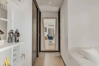 a hallway with a mirror and a chair in a room at Life 1202 - Pleasant Apt in Poblado with AC in El Poblado