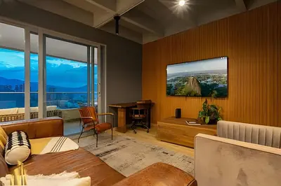 a living room with a table and a desk at Life 1603 - Panoramic & Tastefully Decorated Loft in El Poblado