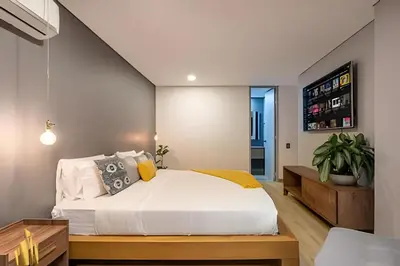 a bedroom with a large white bed in a room at Life 1603 - Panoramic & Tastefully Decorated Loft in El Poblado