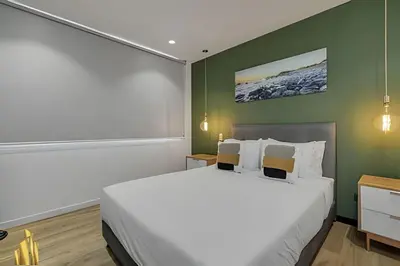 a bedroom with a large bed and a green wall at Life 801 - Exclusive & Bright Apt/pool/gym/balcony in El Poblado
