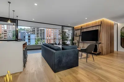 a living room with a couch and a flat screen tv at Life 801 - Exclusive & Bright Apt/pool/gym/balcony in El Poblado