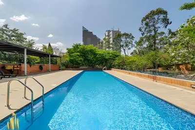 a large swimming pool with blue water at Life 801 - Exclusive & Bright Apt/pool/gym/balcony in El Poblado