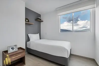 a bedroom with a bed and a window at Metropolitan 2226-Familiar Bright Apt/Priv balcony in El Salvador
