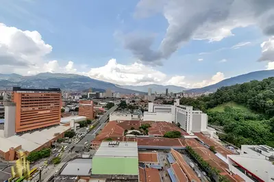 a view of a city with mountains in the background at Metropolitan 2226-Familiar Bright Apt/Priv balcony in El Salvador