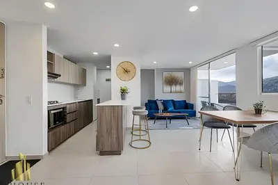 a kitchen and living room with a table and chairs at Metropolitan 2226-Familiar Bright Apt/Priv balcony in El Salvador