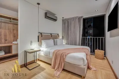 a hotel room with a bed and a television at Morph 1001 - Exclusive apt in Poblado/BBQ in El Poblado