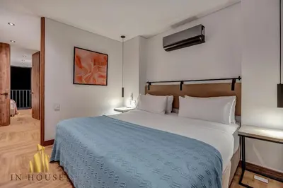 a bedroom with a large bed with a blue blanket at Morph 1001 - Exclusive apt in Poblado/BBQ in El Poblado