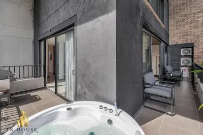 a bath tub in a room with a balcony at Morph 1002 - Luxe apt in Poblado/AC/BBQ in El Poblado