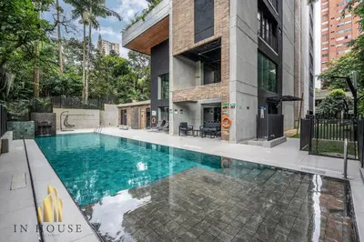 a swimming pool in front of a building at Morph 1002 - Luxe apt in Poblado/AC/BBQ in El Poblado