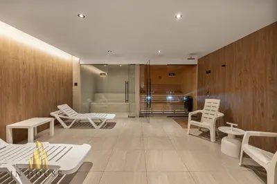 a room with white chairs and a bath tub at Morph 1002 - Luxe apt in Poblado/AC/BBQ in El Poblado