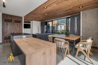a kitchen and living room with a table and chairs at Morph 1002 - Luxe apt in Poblado/AC/BBQ in El Poblado