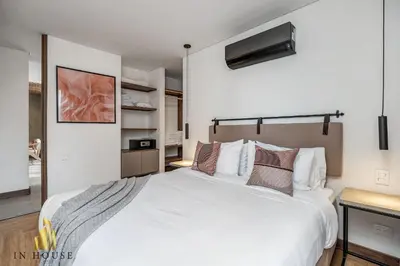a bedroom with a large white bed in a room at Morph 1002 - Luxe apt in Poblado/AC/BBQ in El Poblado