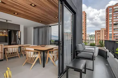 an apartment with a balcony with a table and chairs at Morph 1101 - Sophisticated & brigh apt/ BBQ in El Poblado