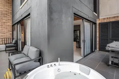 a bathroom with a bath tub and a chair at Morph 1101 - Sophisticated & brigh apt/ BBQ in El Poblado