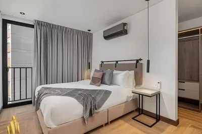 a bedroom with a large bed and a window at Morph 1101 - Sophisticated & brigh apt/ BBQ in El Poblado