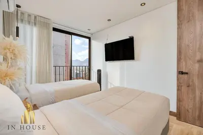 a bedroom with two beds and a flat screen tv at Morph 1201 - Elegant/Modern Apt in Poblado in El Poblado