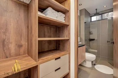 a bathroom with wooden cabinets and a toilet at Morph 1201 - Elegant/Modern Apt in Poblado in El Poblado