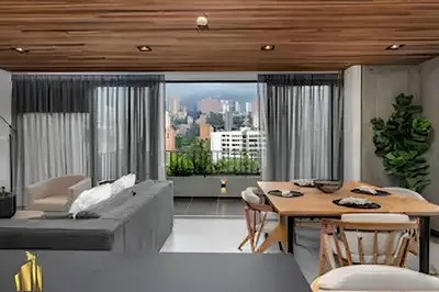 a living room with a couch and a table at Morph 1202 - Stylish City Living: Modern Apt in El Poblado