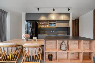 a kitchen with a large wooden table and chairs at Morph 1202 - Stylish City Living: Modern Apt in El Poblado