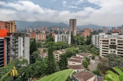 a view of a city with buildings and trees at Morph 1202 - Stylish City Living: Modern Apt in El Poblado