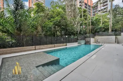 an empty swimming pool in a building with trees at Morph 1202 - Stylish City Living: Modern Apt in El Poblado