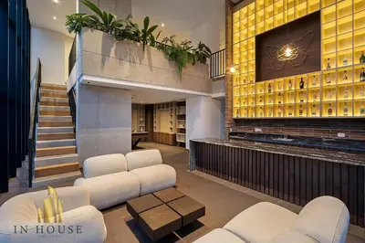 a lobby of a house with white chairs and a tv at Morph 1202 - Stylish City Living: Modern Apt in El Poblado
