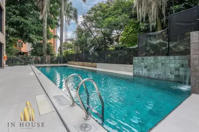a swimming pool with blue water in a building at Morph 1301 - Chill Haven BBQ, Jacuzzi, AC in El Poblado