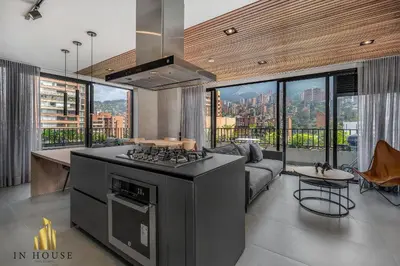 a kitchen with a stove top oven in a living room at Morph 1301 - Chill Haven BBQ, Jacuzzi, AC in El Poblado