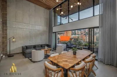 a dining room with a table and a couch at Morph 1302 - Spacious & private apt w BBQ/Jacuzzi in El Poblado