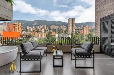 a bathroom with a tub and two chairs and a bath tub at Morph 1302 - Spacious & private apt w BBQ/Jacuzzi in El Poblado