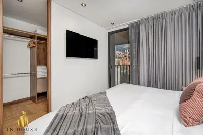 a bedroom with a bed and a window with a tv at Morph 1302 - Spacious & private apt w BBQ/Jacuzzi in El Poblado
