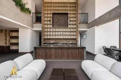 a lobby with white couches and a wall with a clock at Morph 1401 - Luxe & bright ap in Poblado with AC in El Poblado