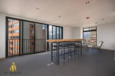 a large room with a table and chairs on a balcony at Morph 1401 - Luxe & bright ap in Poblado with AC in El Poblado