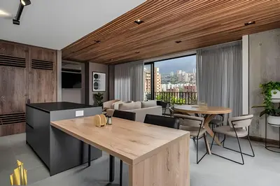 a kitchen and living room with a table and chairs at Morph 1402 - Stylish apt in Poblado/AC/Jacuzzi in El Poblado