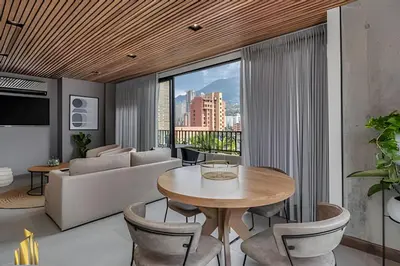 a living room with a table and a couch at Morph 1402 - Stylish apt in Poblado/AC/Jacuzzi in El Poblado