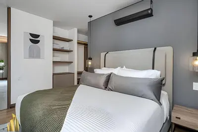 a bedroom with a bed with white sheets and pillows at Morph 1402 - Stylish apt in Poblado/AC/Jacuzzi in El Poblado