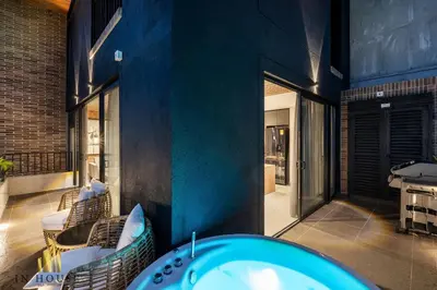 a bathroom with a tub and a table and chairs at Morph 1501 - Vibrant apt in Poblado/AC/Jacuzzi/BBQ in El Poblado