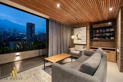 a living room with a couch and a large window at Morph 1501 - Vibrant apt in Poblado/AC/Jacuzzi/BBQ in El Poblado