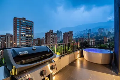 a bathroom with a tub and a grill on a balcony at Morph 1501 - Vibrant apt in Poblado/AC/Jacuzzi/BBQ in El Poblado
