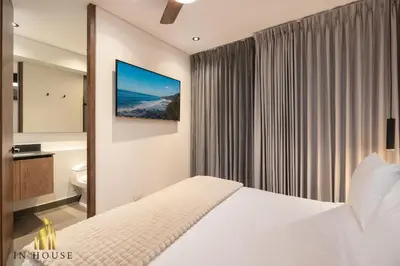 a bedroom with a white bed and a window at Morph 1501 - Vibrant apt in Poblado/AC/Jacuzzi/BBQ in El Poblado