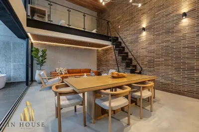 a dining room with a table and chairs and a brick wall at Morph 1601 - Exclusivity in Poblado/Jacuzzi in El Poblado