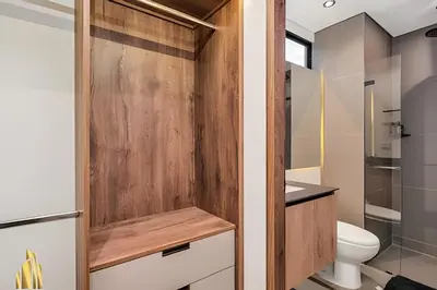 a bathroom with a wooden door and a toilet at Morph 1602 - Luxury escape in Poblado/Jacuzzi/AC in El Poblado