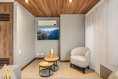 a living room with a chair and a table at Morph 1602 - Luxury escape in Poblado/Jacuzzi/AC in El Poblado