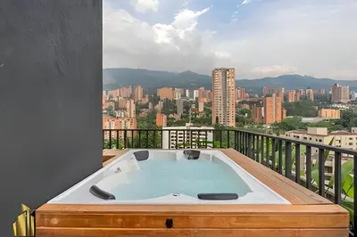 a hot tub on a balcony with a view of a city at Morph 1602 - Luxury escape in Poblado/Jacuzzi/AC in El Poblado