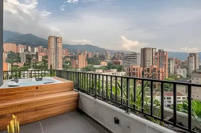 a hot tub on a balcony with a view of a city at Morph 1602 - Luxury escape in Poblado/Jacuzzi/AC in El Poblado