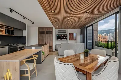 a kitchen and dining room with a wooden table and chairs at Morph 1802 - Stylish Escape in Poblado AC/Jacuzzi in El Poblado