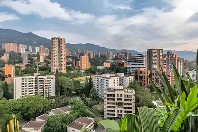 a city with tall buildings and mountains in the background at Morph 1802 - Stylish Escape in Poblado AC/Jacuzzi in El Poblado